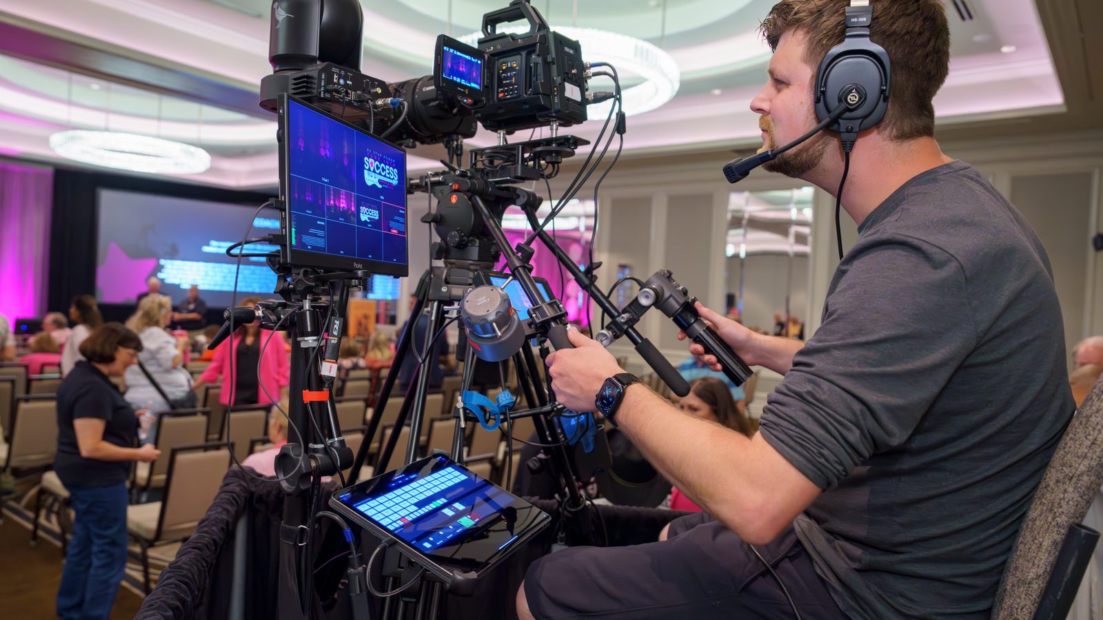 Event Video Pros camera operator on comms covering a general session